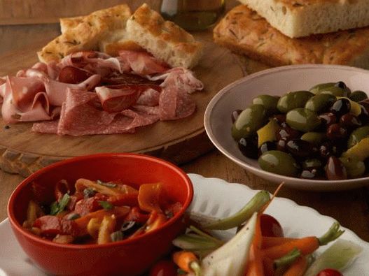 Photo of Antipasti of baked peppers, pinzimonio and pickled olives