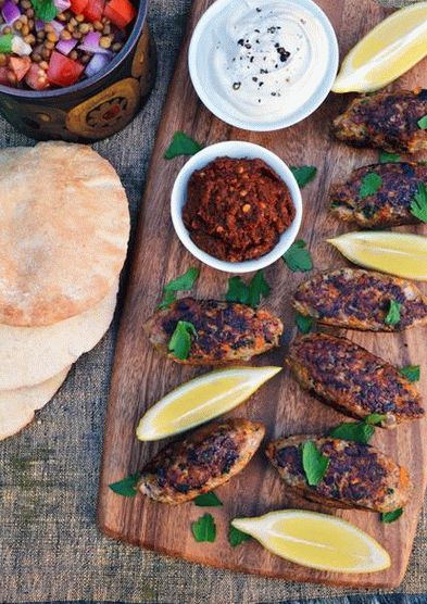 Photo of a grilled sandwich with a lamb cutlet and Muhammara sauce
