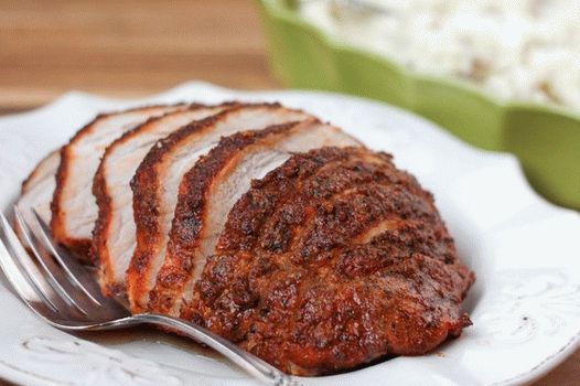 Photo of boiled pork in a slow cooker with herbs