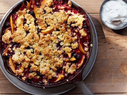 Photo Blueberry-peach cobbler with charcoal bourbon