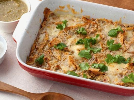 Photo of Chilakiles - a casserole with crispy chips, cheese and an egg