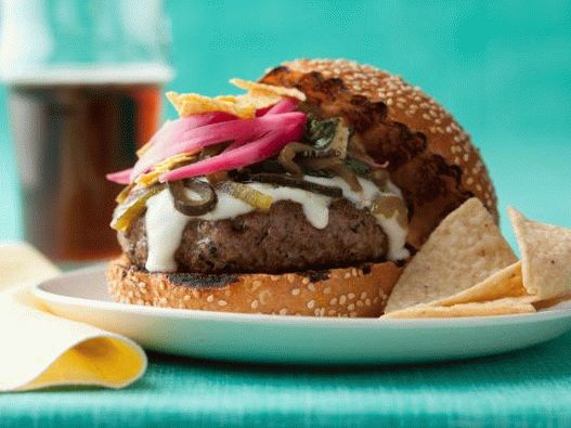 Photo of a Cheeseburger with Cheese Sauce and Green Chili Peppers