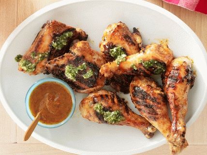Photo of a BBQ chicken with chipotle pepper, mango and chimichurri sauce