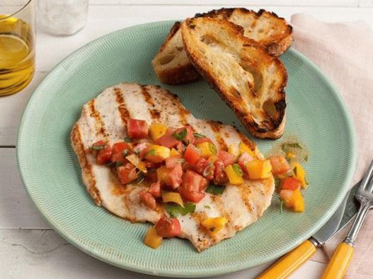 Photo of grilled chicken escalopes with tomato and greens salad