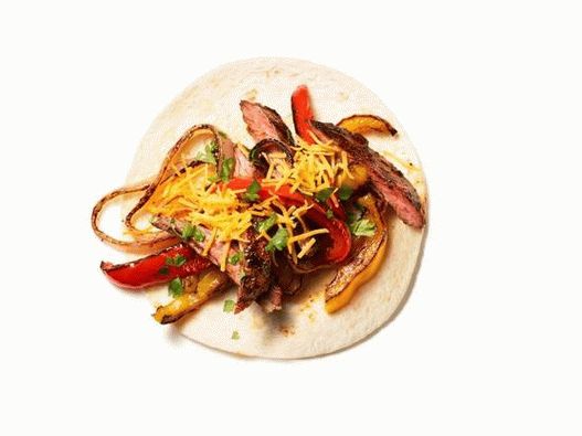 Photo of Fajitas with steak, onions and sweet pepper
