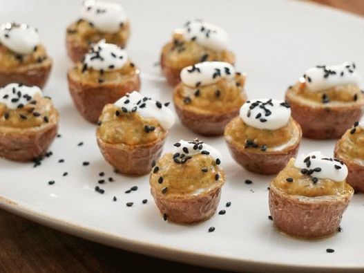 Photo Stuffed potatoes stuffed with eggplant caviar with baked garlic and sour cream