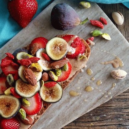 Photo Fruit salad with sweet yogurt dressing for topping on toasts