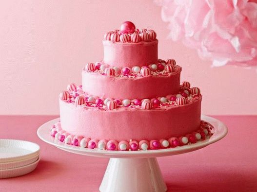Photo of a birthday cake with bright pink butter icing