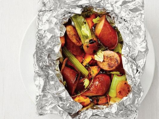 Photo of sausage with sweet potato in grilled foil parcels