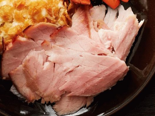 Photo Smoked pork ham baked in sugar-honey glaze