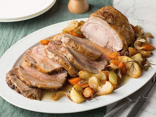 Photo of a loin in the oven with fried apples and gravy