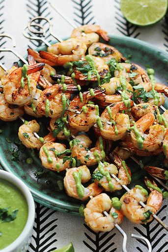 Photo of Grilled prawns on skewers with mustard-dill dressing and yogurt sauce with olives