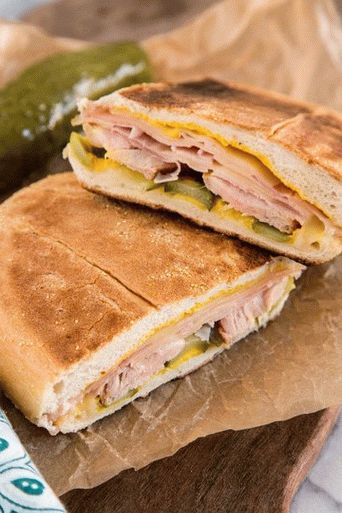 Photo of a Cuban sandwich on a French bun