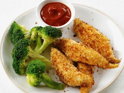 Photo of chicken fingers with a side dish of steam broccoli