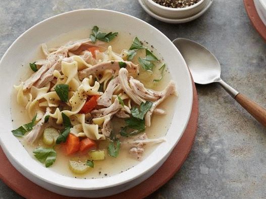 Photo Chicken noodle soup in a slow cooker