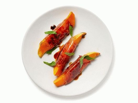 Photo of sliced   nutmeg pumpkin wrapped in prosciutto