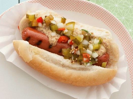 Hot dog with grilled sausage and homemade pickled cucumber sauce