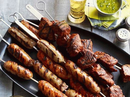 Steak and sausage skewers with two Latin American sauces