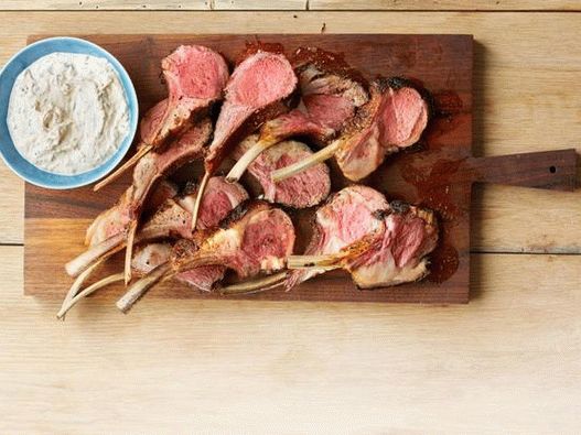 Rack of lamb in a mixture of spices with yogurt sauce with fresh herbs
