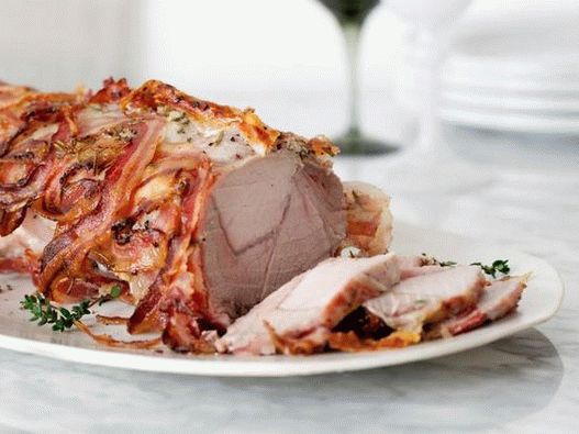 Pork loin wrapped in bacon in the oven