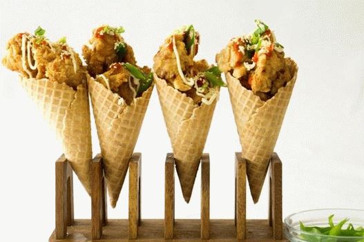 Nuggets and potatoes in a waffle cone