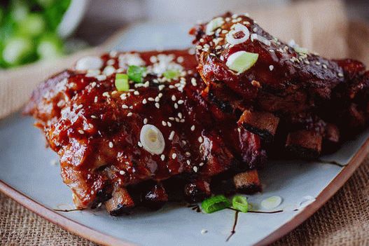 Spicy Asian-style ribs in pineapple-ginger barbecue sauce with sesame seeds