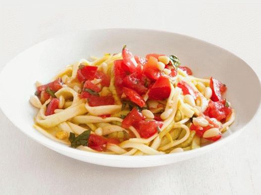 Fresh zucchini fettuccine pasta with spicy tomato sauce and slices