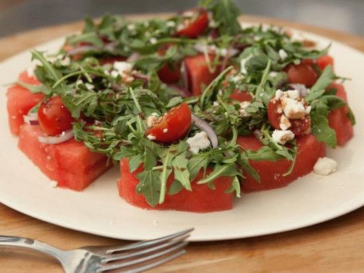 Watermelon slices with cherry tomatoes, feta and arugula