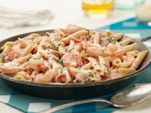 Penne with shrimp and creamy sauce with herbs