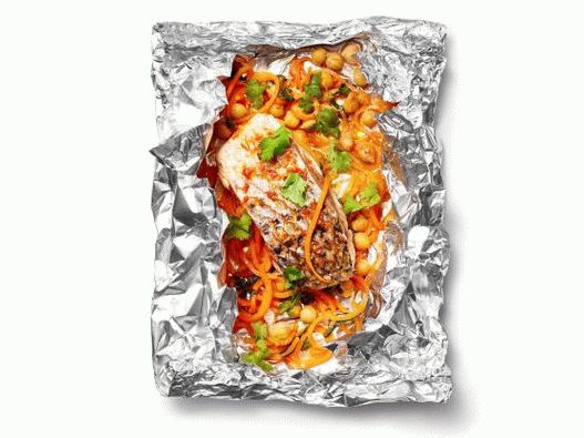 Photo of grilled sea bass in foil with spicy carrots and chickpeas