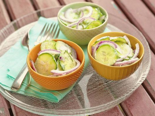 Photo Cucumber salad with sour cream and a labe