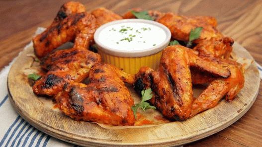 Photo of Spicy chicken wings on the grill