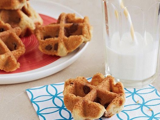 Photo of cookies with pieces of chocolate in a waffle iron