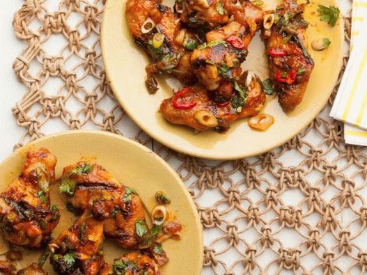 Photo Smoked chicken wings grilled with pickled red chili and dates