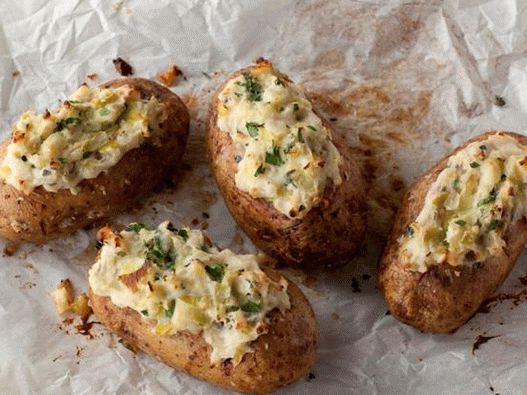 Baked potatoes stuffed with garlic and onion puree