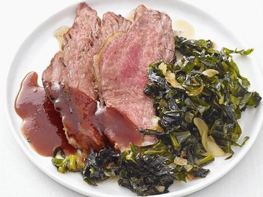 Delicate steak with a sharp crust and a side dish of stewed kale