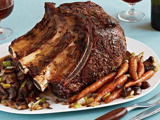 Beef loin on the bones in the oven with vegetables