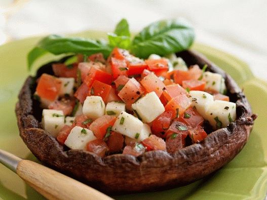 Photo Caprese Salad in mushroom caps on the grill