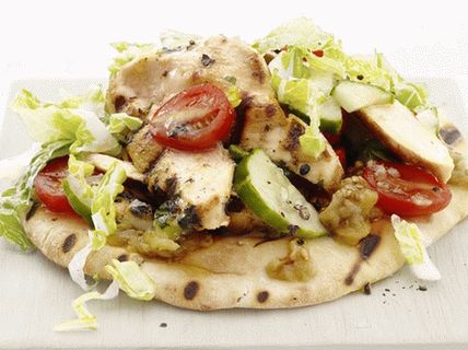 Photo Salad on a tortilla with fried chicken breast