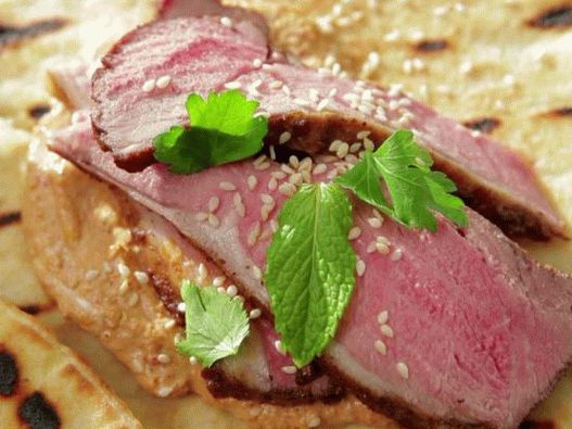 Photo of lamb shawarma in ras al-khanut marinade with sweet pepper and walnut tahini sauce
