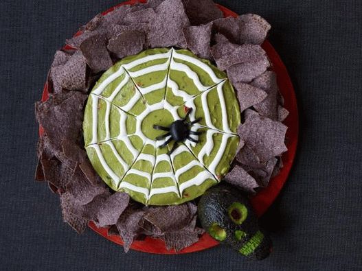 Photo of Halloween guacamole sauce with spider web