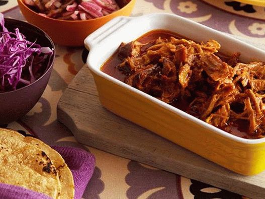 Photo of Tacos with torn pork in a slow cooker