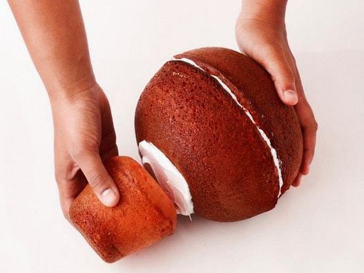 Cut a small cake from the mug on one side, then use a cream to attach to the large cake layers