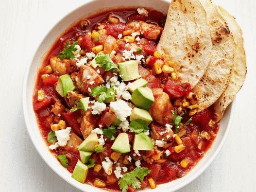 Photo stewed chicken with chipotle pepper in a slow cooker