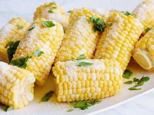 Photo of boiled corn on the cob with parmesan