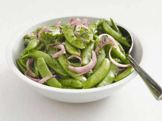 Sugar peas in pods with red onions and herbs