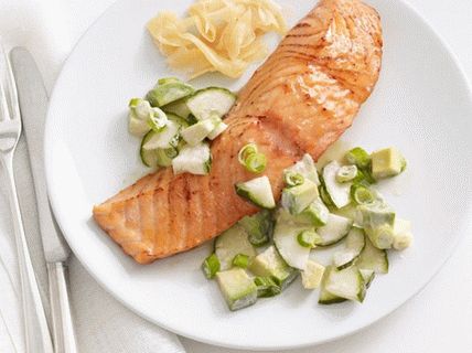 Photo of Baked salmon in soy glaze with a salad of cucumbers and avocados