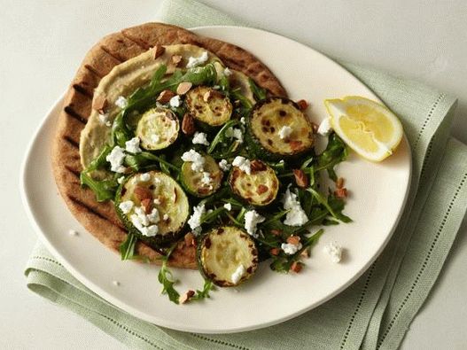 Tortilla with baked zucchini, hummus, arugula, goat cheese and almonds