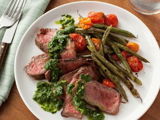Steak and green beans with grilled tomatoes and chimichurri sauce