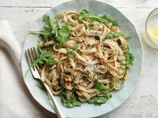 Fettuccine pasta with walnuts and arugula